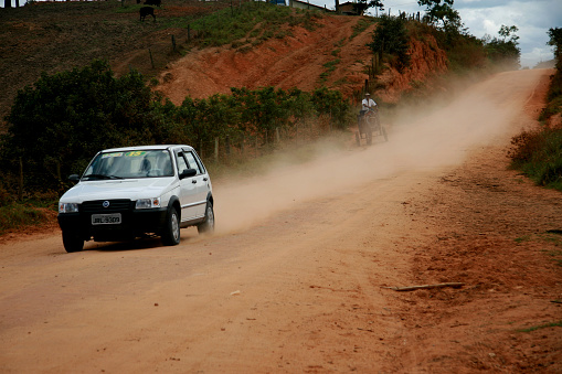 itamaraju, bahia / brazil - august 6, 2008: vehicle travels on a dirt road that connects the municipalities of Itamaraju to Jucurocu in southern Bahia.\