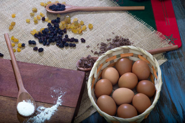 istock Christmas table. making panettone. with chocolate and raisin panettone. rustic table with wood and dark background. copy space 1286054940