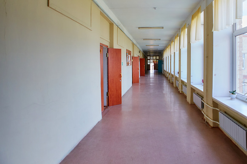 An empty school corridor stretching into the future. The concept of holidays, quarantine, evacuation.