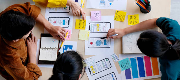 istock Brainstorm planing creative asian teamwork, Group of asia mobile phone app developer team meeting for ideas about screen display prototype smartphone layout, ux startup small business, top view 1286058104