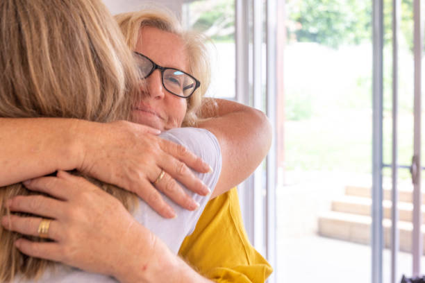 istock Middle Aged Women Comforting Each Other While Talking in the Kitchen 1286061622