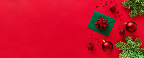 istock Christmas letter with greeting card and congratulations, christmas tree branches, baubles, glitter decorations on red surface. Merry Christmas happy New Year concept. Flat lay, copy space 1286065598