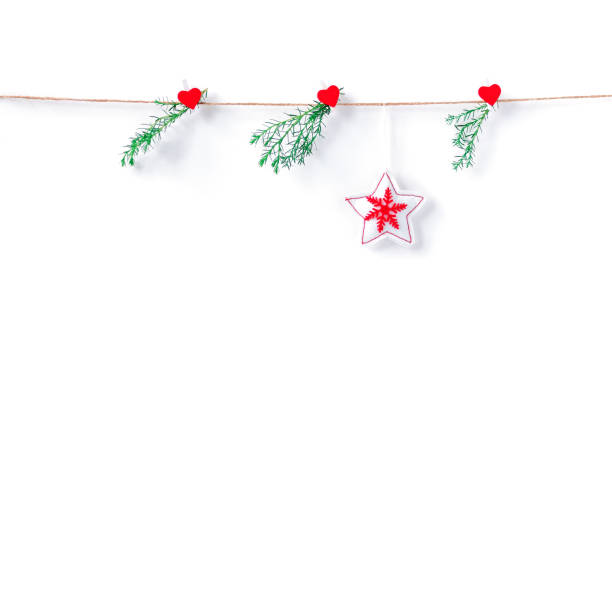 istock A star made of white fabric with a red Christmas pattern hangs on a rope. Coniferous branches are suspended nearby. Christmas, New Year, winter concept. Copy space. 1286065756