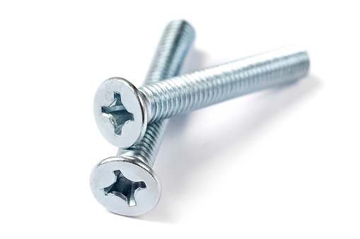 two metal threaded screws for steel on a white background. Close-up of screws for construction