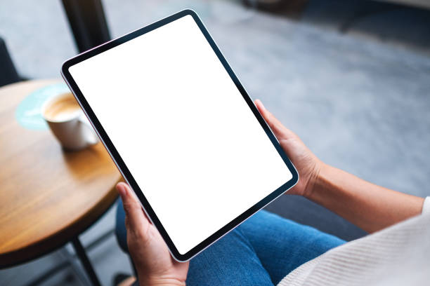 istock a woman holding digital tablet with blank white desktop screen 1286071608