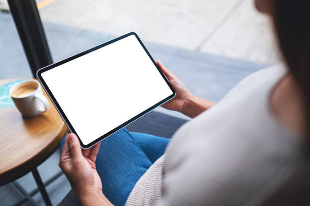istock a woman holding digital tablet with blank white desktop screen 1286071612
