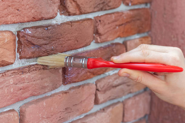 istock Covering of a decorative plaster tile with protective varnish. 1286074095