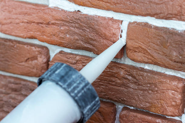 istock Grouting decorative gypsum brick with white cement grout. Closeup. 1286074096