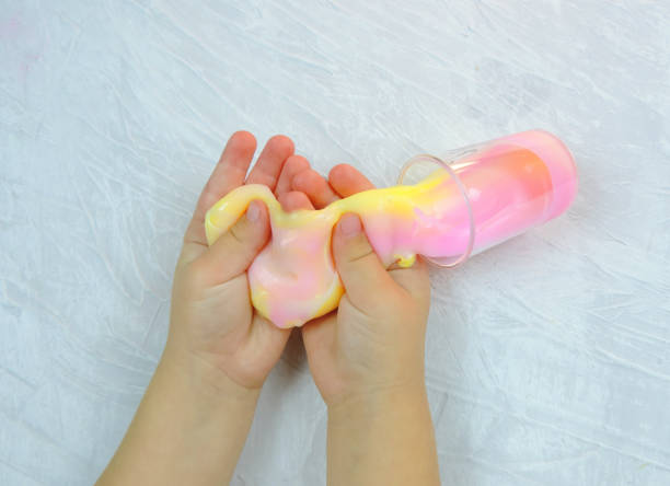 istock slime mass rainbow color, children's hands shake it, children's creativity 1286077498