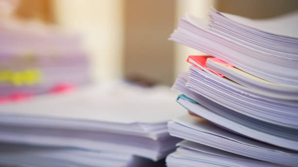 istock Stack of Education report in school, Class documents of Binders file Paperwork folder on teacher desk in university 1286077693