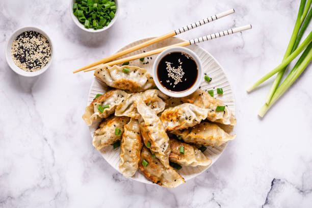 istock Fried dumplings gyoza with soy sauce, and chopsticks, top view 1286079699