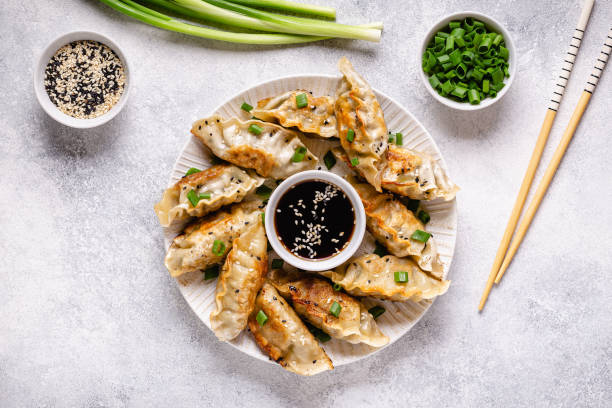 Fried dumplings gyoza with soy sauce, and chopsticks, top view stock photo
