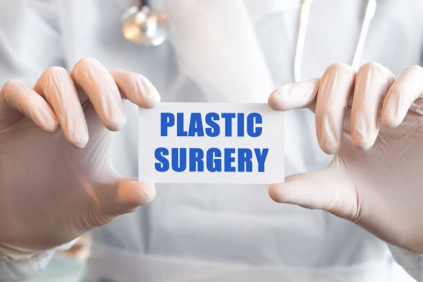 istock Doctor holding a card with text PLASTIC SURGERY, medical concept 1286080051