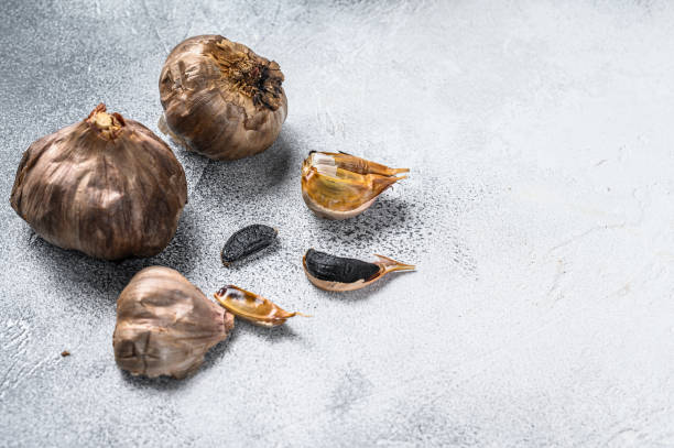 istock Whole balsamic fermented  black garlic. White background. Top view. Copy space 1286080658