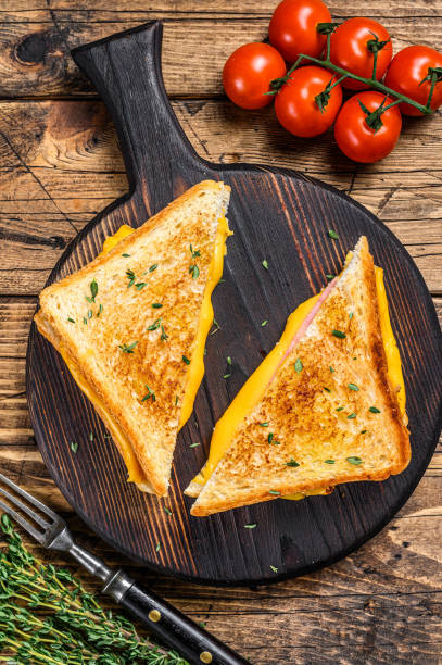 istock American ham and melted cheese sandwich. wooden background. Top view 1286081749