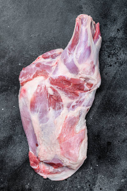 istock Raw lamb shoulder meat. Black background. Top view 1286082812