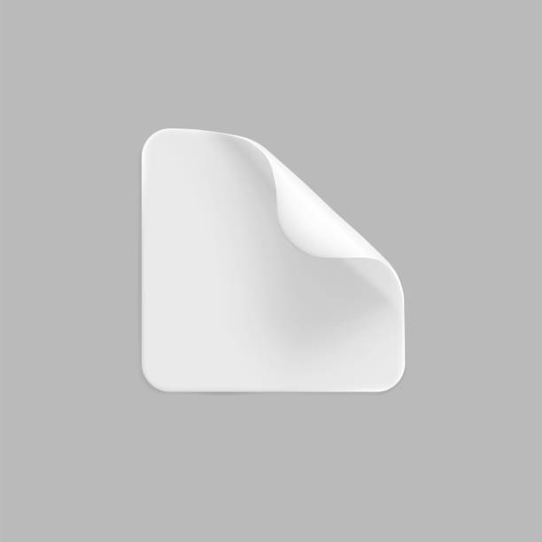 istock White square glued stickers with curled corners mock up set. Blank white adhesive square paper or plastic sticker label with wrinkled, crumpled effect. Blank template label tags. 3d realistic vector 1286086042