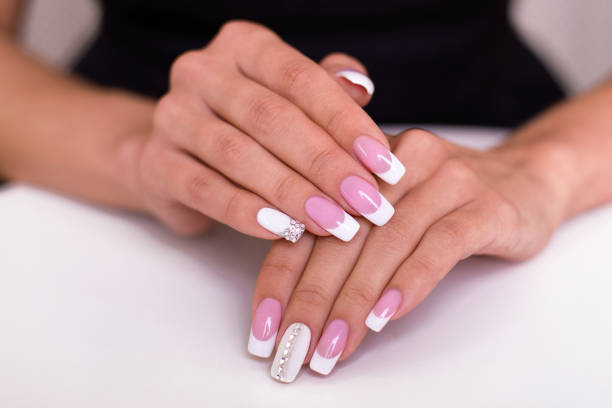 istock Female hands with french manicure 1286086895