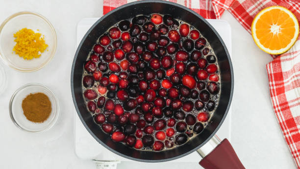 istock Boiling cranberries, cranberry sauce recipe. Ingredients close up on kitchen table, flat lay 1286086997