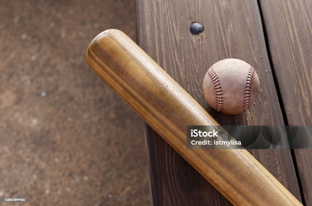 Baseball Bat, and ball on dugout bench. Baseball Bat Stock Photo