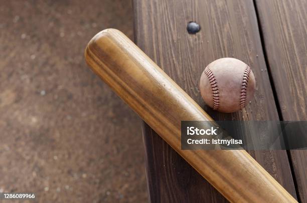 Baseball Bat And Ball On Dugout Bench Stock Photo - Download Image Now - Baseball Bat, Wood - Material, Sports Ball