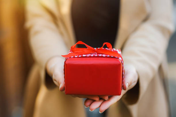 istock Unrecognizable woman's hands holding a beautifully wrapped gift. Birthday / Christmas concept. 1286094046