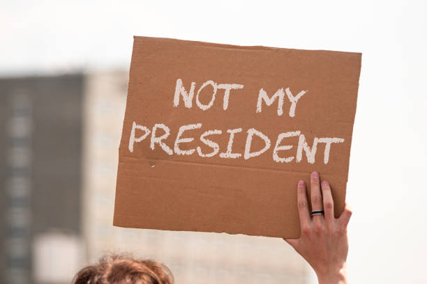 istock woman holding not my president protest banner 1286097826
