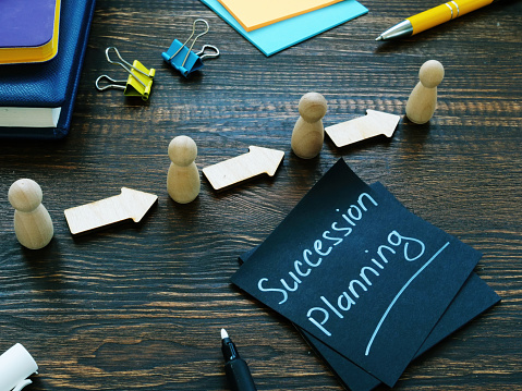 Succession planning and figurines with arrows.