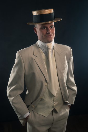 Edwardian style man in boater hat and suit.