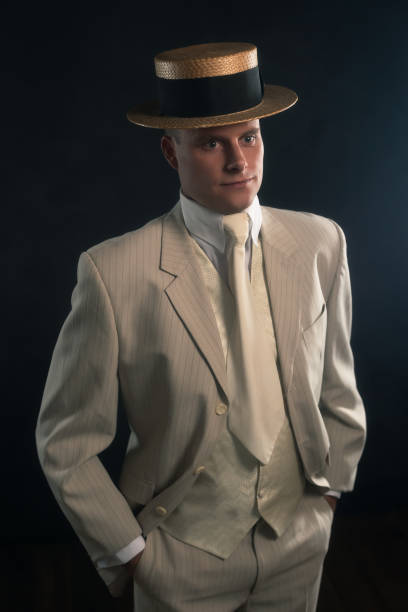 istock Man wearing boater hat and suit standing inside. 1286097922