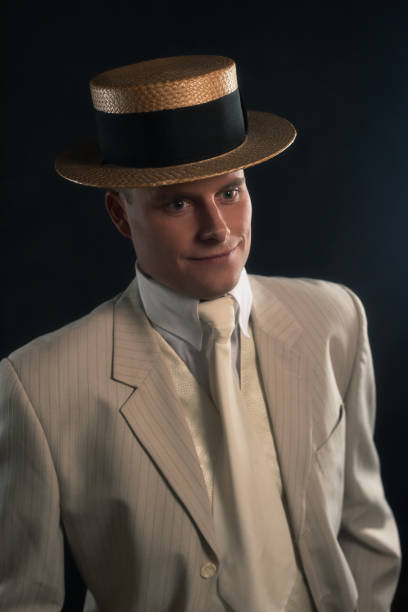 istock Man wearing suit and boater hat standing inside. 1286097923