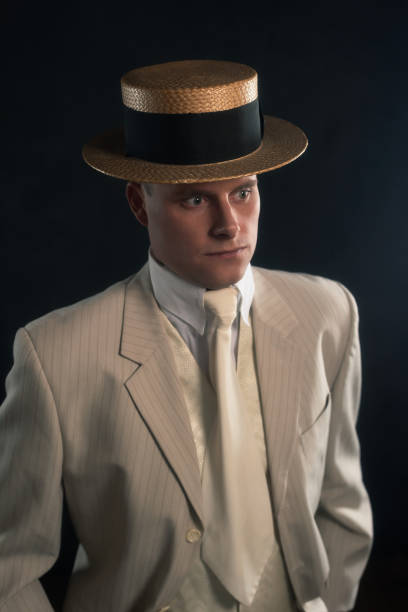 istock Man wearing boater hat and suit standing inside. 1286097925