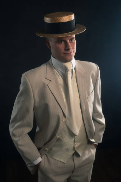 istock Man wearing boater hat and suit standing inside. 1286097939