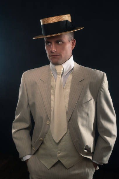 istock Man wearing boater hat and suit standing inside. 1286097945