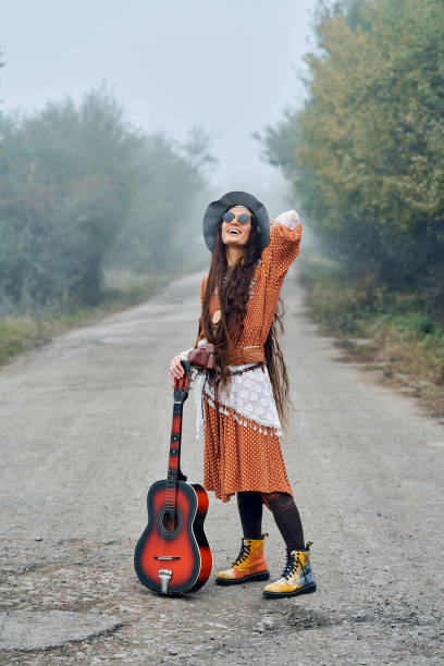 istock Beautiful hippie girl with guitar 1286098373