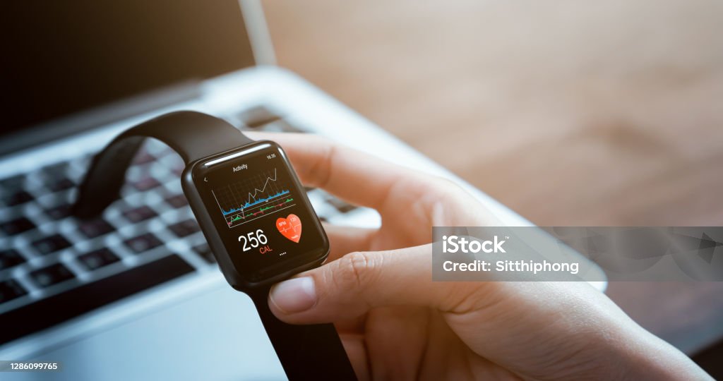 Close up of hand touching smartwatch with health app on the screen, gadget for fitness active lifestyle. Smart Watch Stock Photo
