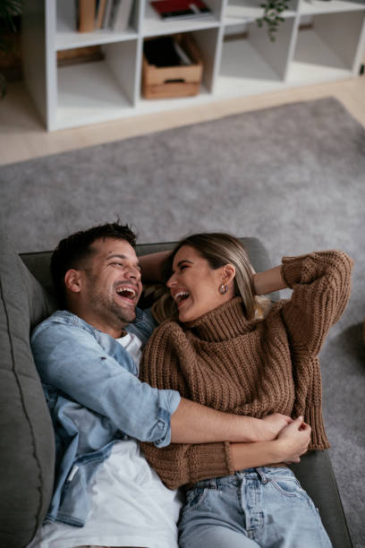 istock Young loving couple relaxing on sofa together. 1286100937