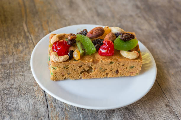 Fruitcake with dried apples, nuts and fresh grapes