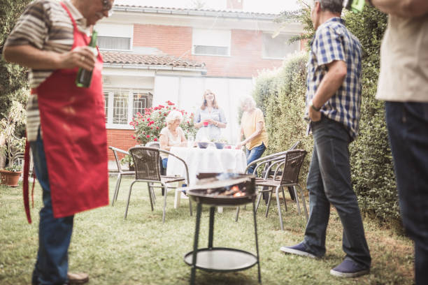 istock Senior people, friends, enjoying backyard barbecue 1286104328