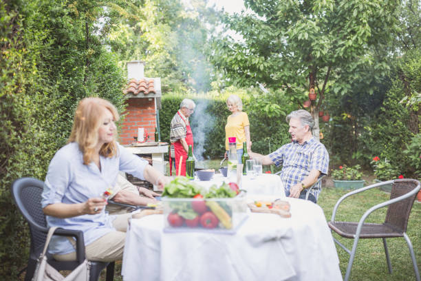 istock Senior people, friends, enjoying backyard barbecue 1286104396