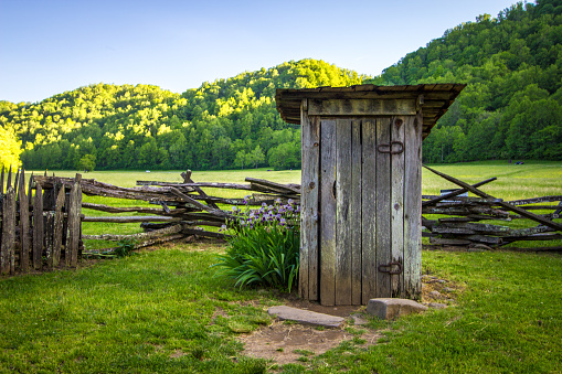 Old wooden outhouse on display as a historical structure located within the Great Smoky Mountains National Park In Tennessee.