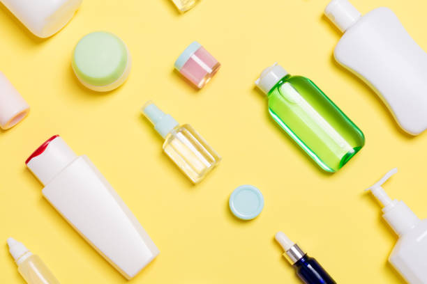 istock Top view of different cosmetic bottles and container for cosmetics on yellow background. Flat lay composition with copy space 1286107985