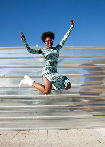 Young woman jumping of happiness