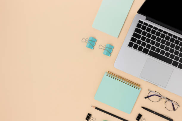 istock Workspace with laptop and office supplies on a beige background. 1286112809