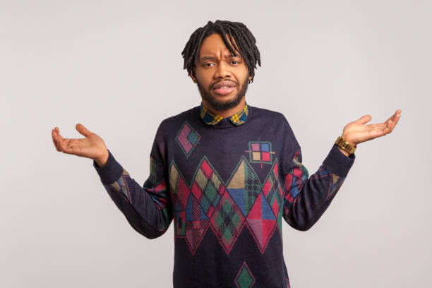 istock I dont know. Confused african man with beard and dreadlocks throwing up his hands, puzzled, uncertain, cant find answer to question 1286112948