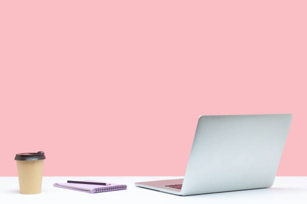 istock Empty workplace, paper cup and notepad with pencil lying on table near open laptop, break time, end of the working day 1286113960