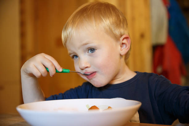 istock Little boy eating at the table. 1286115651