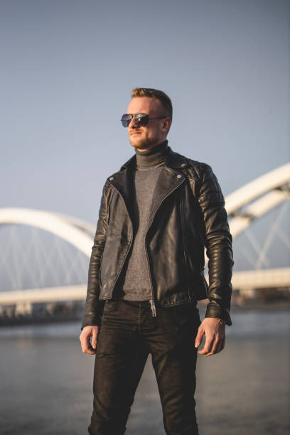 istock Young man relaxing and walking near river 1286115876