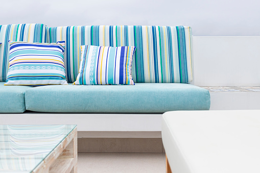 A relaxing spot for a warm, summer day with cute ecological sofa of various colors outdoors