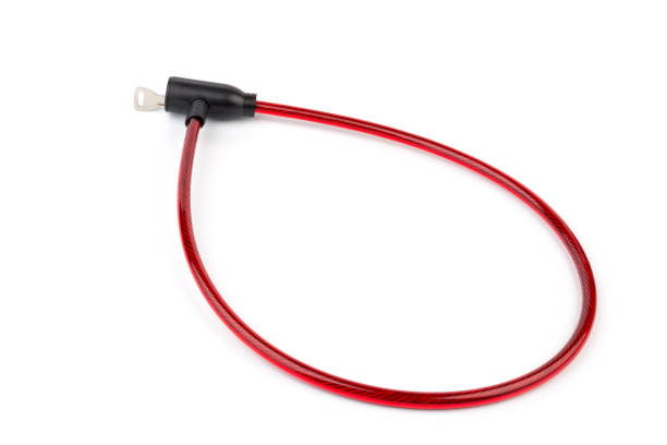 istock Flexible red bicycle cable with key on white background.  Security and safety concept. 1286117284